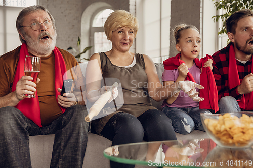 Image of Excited, happy big family team watch football, soccer match together on the couch at home