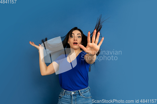 Image of Caucasian woman\'s portrait isolated on blue studio background