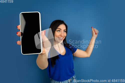 Image of Caucasian woman\'s portrait isolated on blue studio background