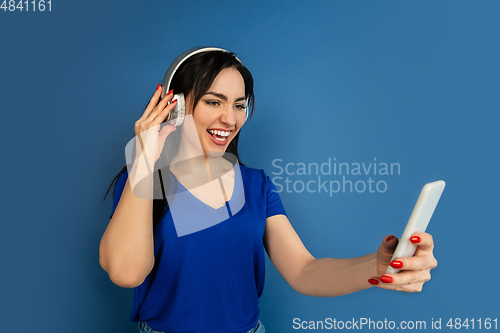 Image of Caucasian woman\'s portrait isolated on blue studio background
