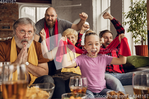 Image of Excited, happy big family team watch football, soccer match together on the couch at home