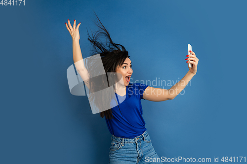 Image of Caucasian woman\'s portrait isolated on blue studio background