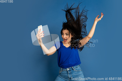 Image of Caucasian woman\'s portrait isolated on blue studio background