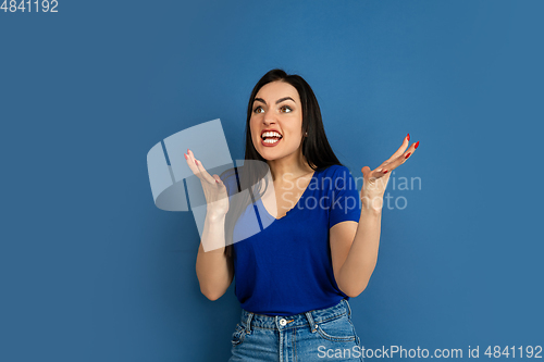 Image of Caucasian woman\'s portrait isolated on blue studio background