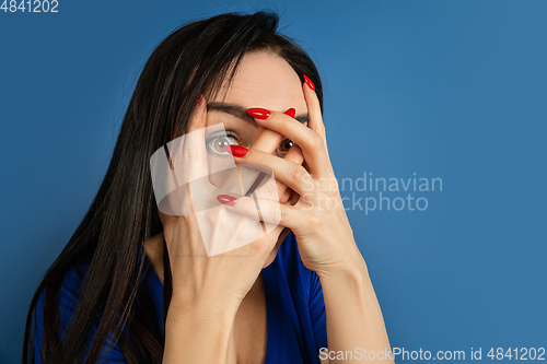 Image of Caucasian woman\'s portrait isolated on blue studio background