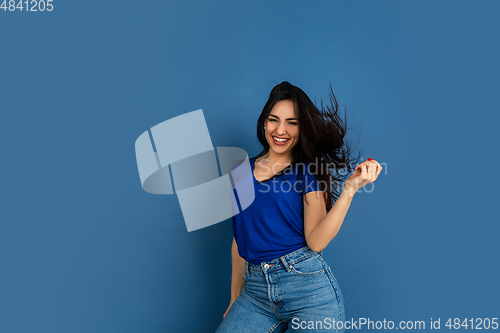 Image of Caucasian woman\'s portrait isolated on blue studio background