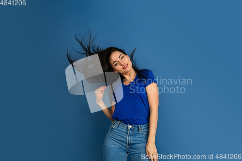 Image of Caucasian woman\'s portrait isolated on blue studio background