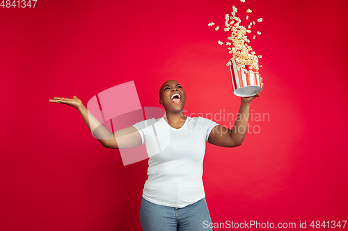 Image of African-american young woman\'s portrait on red background