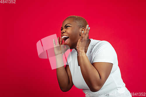 Image of African-american young woman\'s portrait on red background