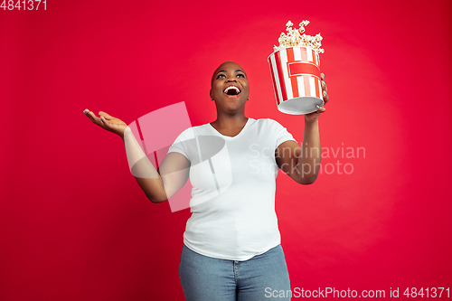 Image of African-american young woman\'s portrait on red background