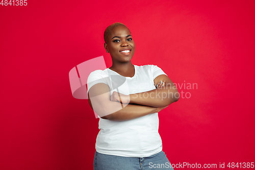 Image of African-american young woman\'s portrait on red background