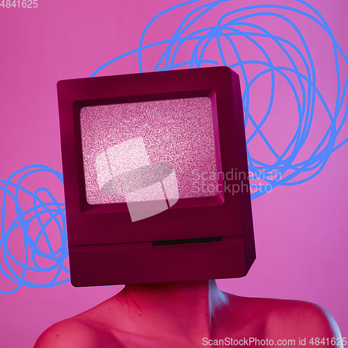 Image of Young woman headed of TV set isolated over pink background.