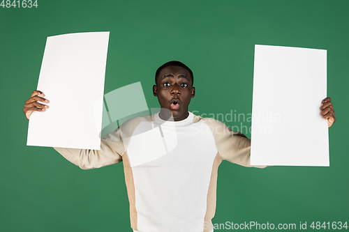 Image of African man\'s portrait isolated on green studio background with copyspace