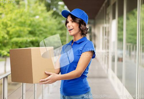 Image of happy delivery girl with parcel box in blue