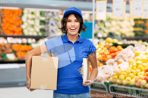 Image of happy delivery girl with box at grocery store