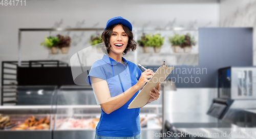 Image of happy delivery girl with clipboard and pen writing