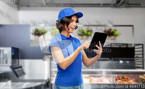 Image of happy smiling delivery girl with tablet pc at shop