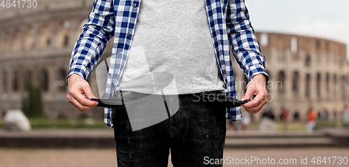 Image of close up of man showing empty pockets in italy