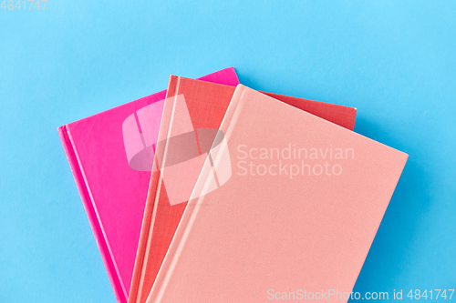 Image of notebooks or books on blue background