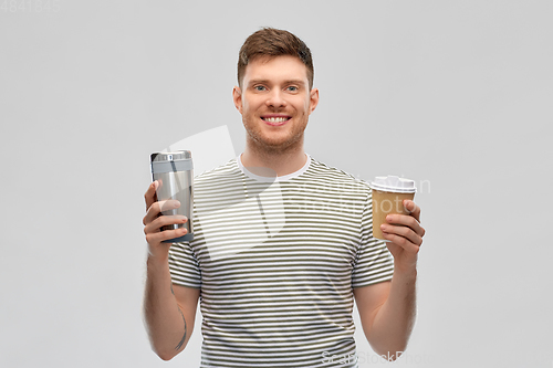 Image of man comparing thermo cup or tumbler and coffee cup