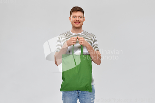 Image of man with reusable canvas bag for food shopping