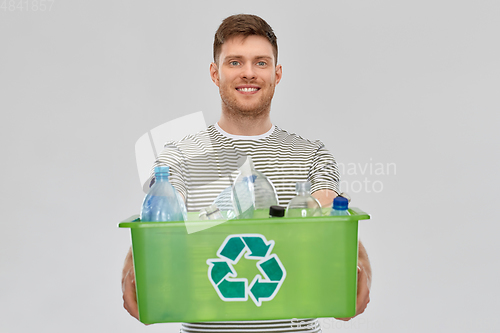 Image of smiling young man sorting plastic waste