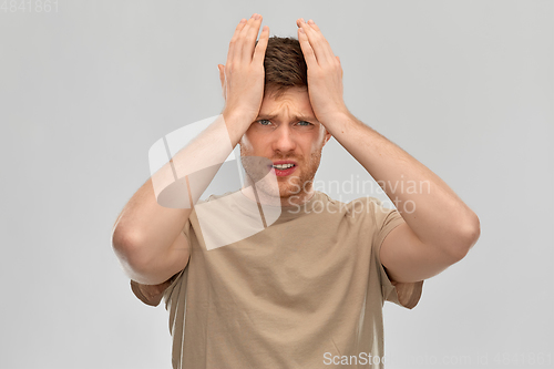 Image of unhappy man suffering from headache