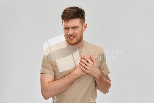 Image of unhappy young man suffering from heartache