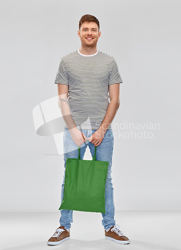 Image of man with reusable canvas bag for food shopping