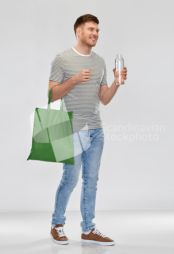 Image of man with bag for food shopping and glass bottle