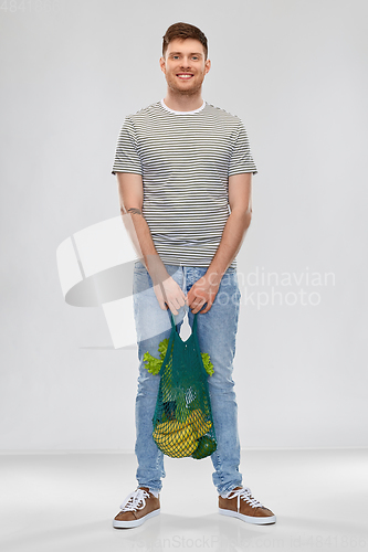 Image of happy man with food in reusable net tote