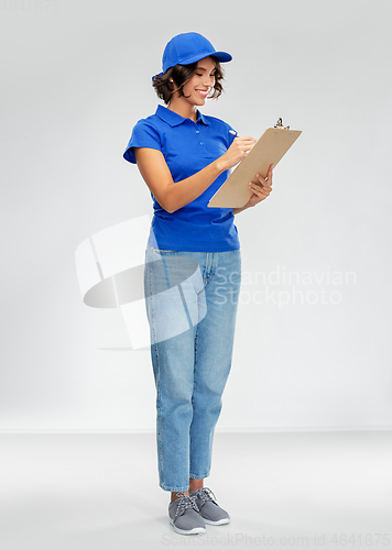 Image of happy smiling delivery woman with clipboard