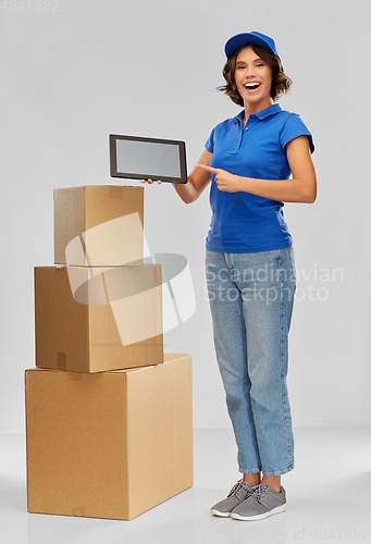 Image of delivery girl with parcel boxes and tablet pc