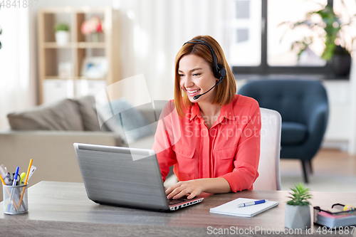 Image of woman with headset and laptop working at home