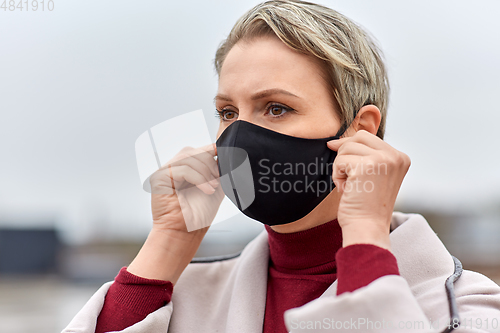 Image of woman wearing protective reusable barrier mask