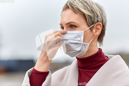 Image of young woman wearing protective medical mask