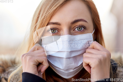 Image of young woman wearing protective medical mask