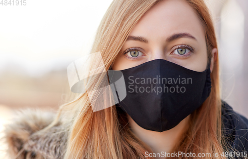 Image of woman wearing protective reusable barrier mask