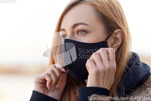 Image of woman wearing protective reusable barrier mask