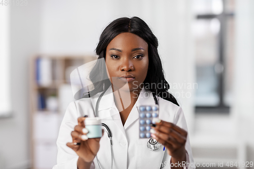 Image of african american doctor with medicine at hospital