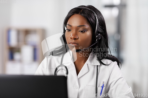 Image of african doctor with headset and laptop at hospital