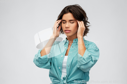 Image of woman having headache holding to her head