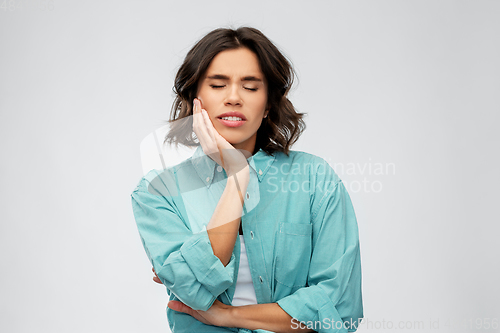 Image of young woman suffering from toothache