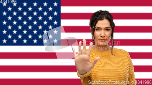 Image of woman showing stop gesture over flag of america