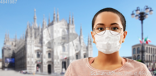 Image of woman in medical mask over milano cathedral, italy