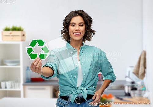 Image of smiling young woman holding green recycling sign
