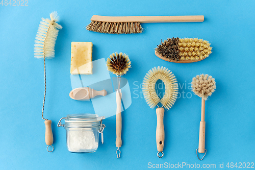 Image of cleaning brushes and soda powder with scoop in jar