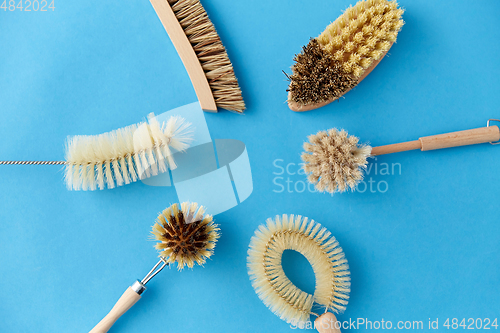 Image of different cleaning brushes on blue background