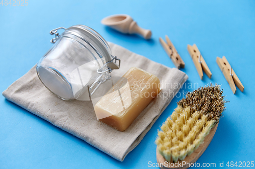 Image of brush, washing soda, soap, scoop and clothespins
