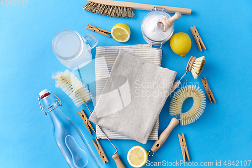 Image of vinegar, lemons, soda, clothespins and brushes